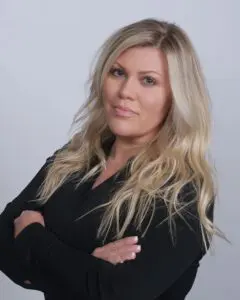 A woman with long blonde hair posing for the camera.